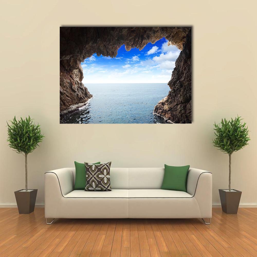 Serene Cave View with Rock Formations Canvas Wall Art in gray, brown and blue, single panel hung on a wall