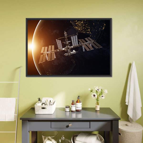 International Space Station Over Planet Earth Canvas Wall Art in black, white and orange, framed canvas, product view on a white background