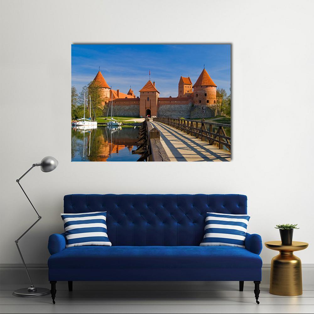 Trakai Island Castle with Wooden Bridge Canvas Wall Art in brown, orange and blue, single panel hung on a wall
