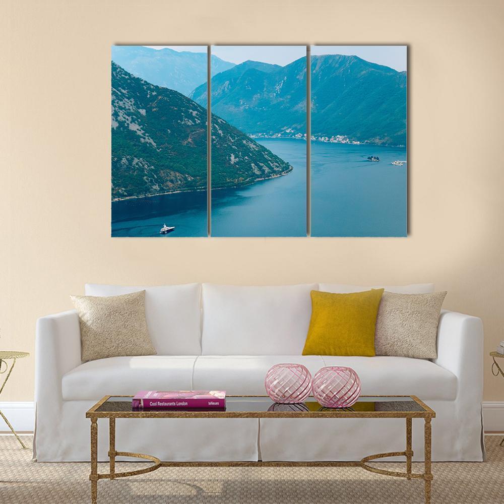 Gospa Od Skrpela Island in Kotor Bay Canvas Wall Art in green and blue, 3 panel horizontal set hung on a wall