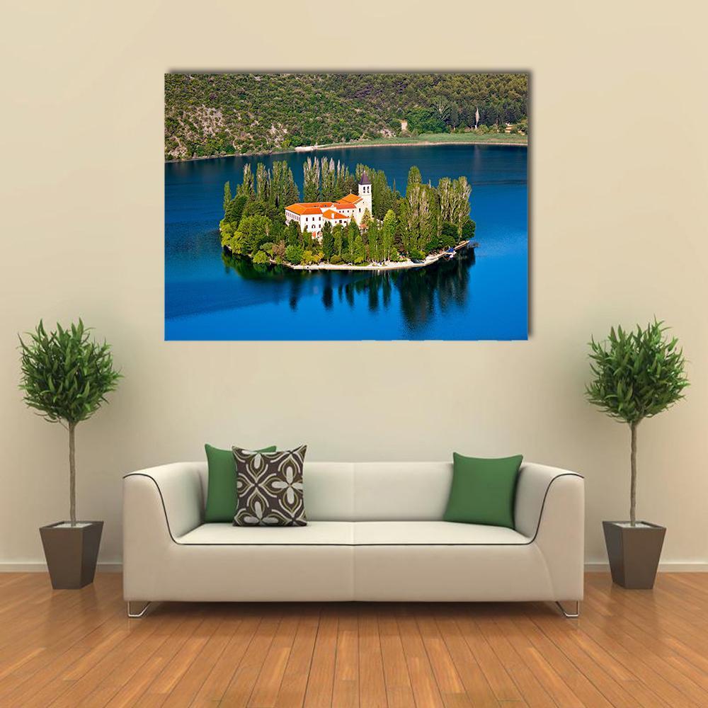 Island on River Krka Canvas Wall Art in green and blue, single panel hung on a wall