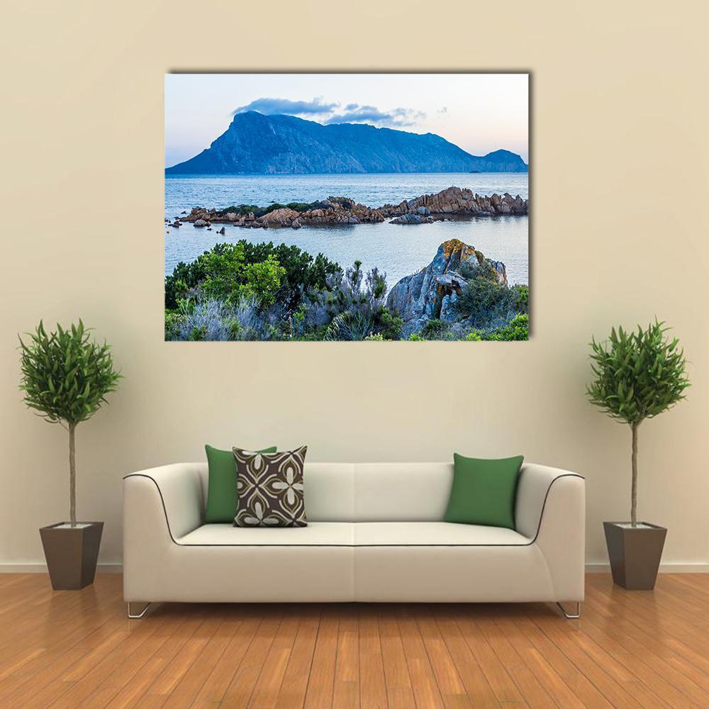 Isola Tavolara Seaside Landscape Canvas Wall Art in gray, green and blue, single panel hung on a wall