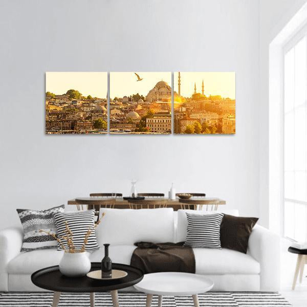 Istanbul Sunset Over Suleymaniye Mosque Panoramic Canvas Wall Art in brown, gold and yellow, hung on a wall