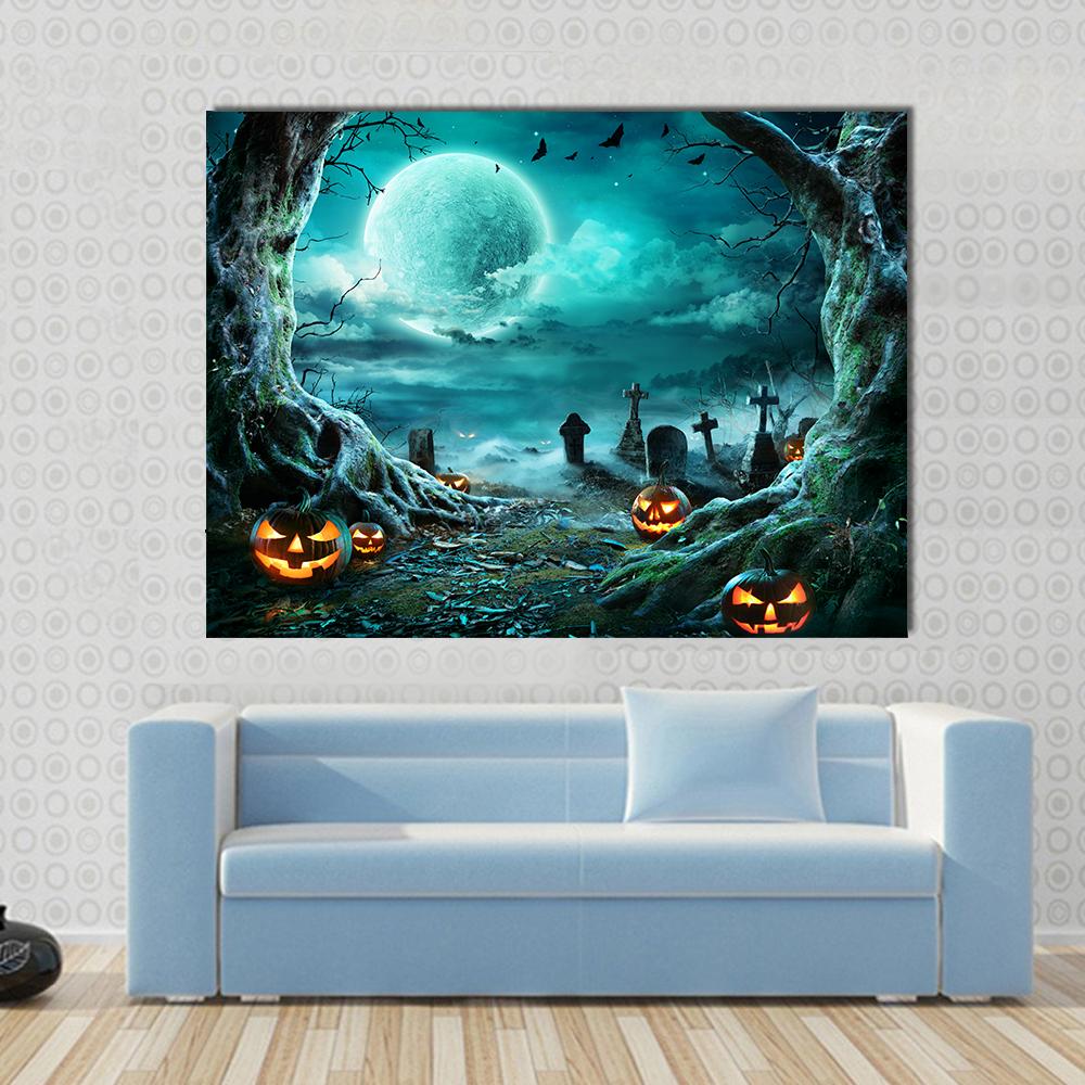 Jack-o'-lanterns in Moonlit Cemetery Canvas Wall Art in black, orange and blue, single panel hung on a wall