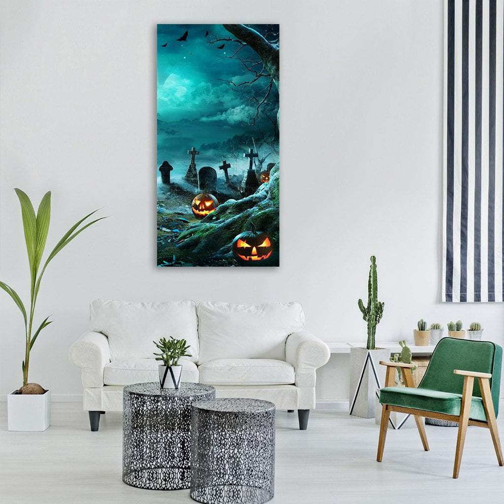 Glowing Jack-o'-lanterns in Moonlit Cemetery Vertical Canvas Wall Art in black, orange and blue, single vertical panel hung on a wall