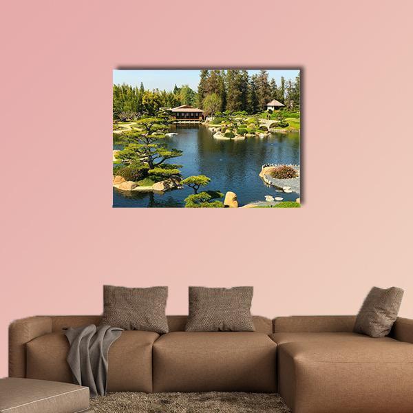 Japanese Garden Pond with Bridge and House Canvas Wall Art in green and blue, single panel hung on a wall