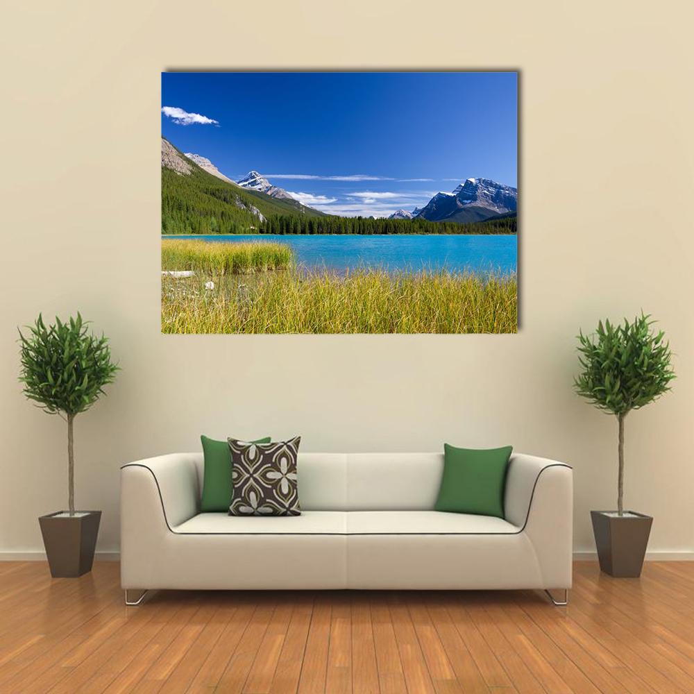 Jasper National Park Lake and Mountains Canvas Wall Art in yellow, green and blue, single panel hung on a wall