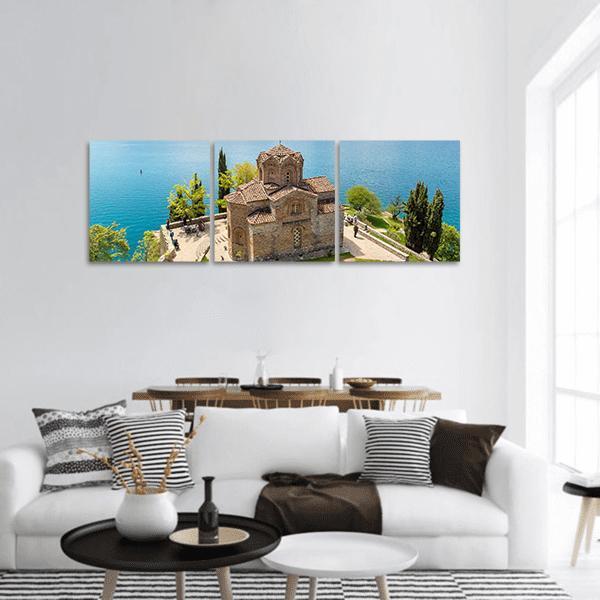 Jovan Kaneo Church Over Lake Ohrid Panoramic Canvas Wall Art in brown, green and blue, hung on a wall