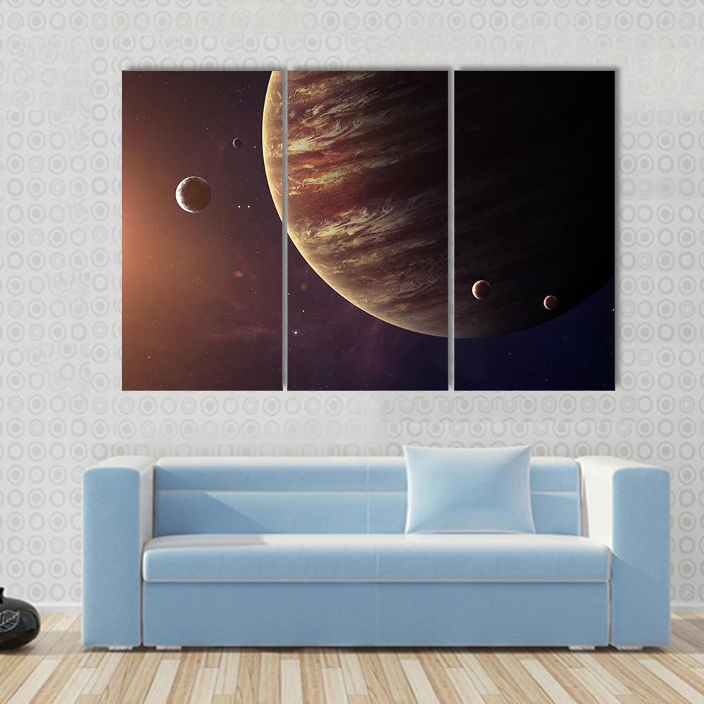 Jupiter with Its Moons Canvas Wall Art in black, brown and orange, 3 panel horizontal set hung on a wall