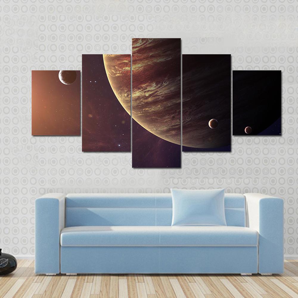 Jupiter with Its Moons Canvas Wall Art in black, brown and orange, 5 panel Star layout hung on a wall