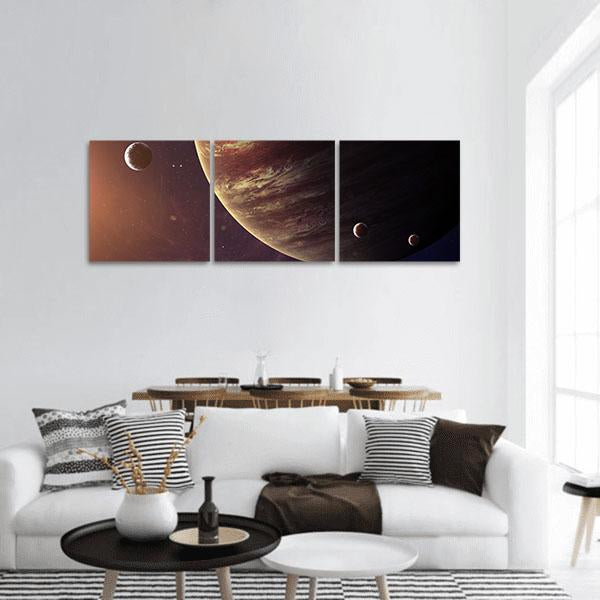 Jupiter with Three Moons Panoramic Canvas Wall Art in black, brown and orange, hung on a wall