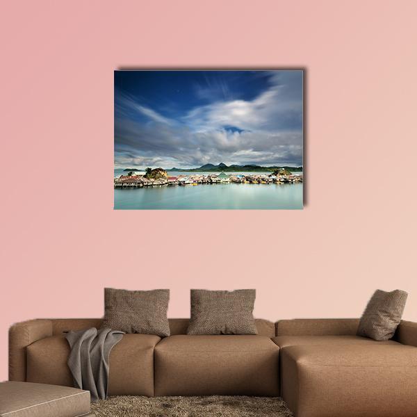 Kabalutan Overwater Village Indonesia Canvas Wall Art in white, green and blue, single panel hung on a wall
