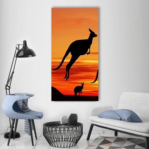 Leaping Kangaroo Silhouette at Sunset Vertical Canvas Wall Art in black, orange and yellow, single vertical panel hung on a wall