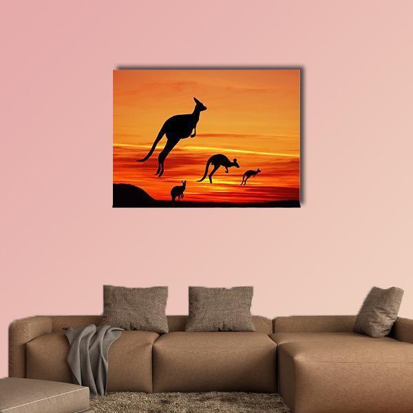 Five Kangaroos in Silhouette at Sunset Canvas Wall Art in black, orange and yellow, single panel hung on a wall