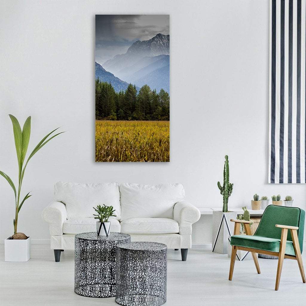Misty Alpine Mountains and Pine Forest Vertical Canvas Wall Art in gray, yellow and blue, single vertical panel hung on a wall