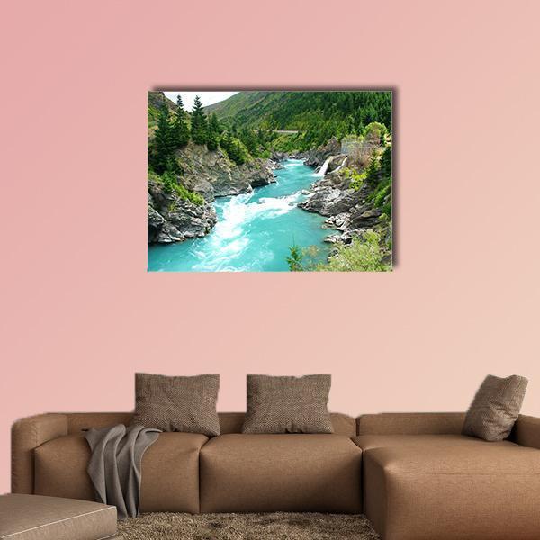 Kawarau River and Forest Canvas Wall Art in gray, green and blue, single panel hung on a wall