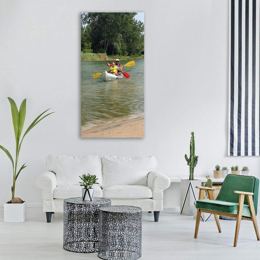Tandem Kayak on a River Vertical Canvas Wall Art in beige and green, single vertical panel hung on a wall