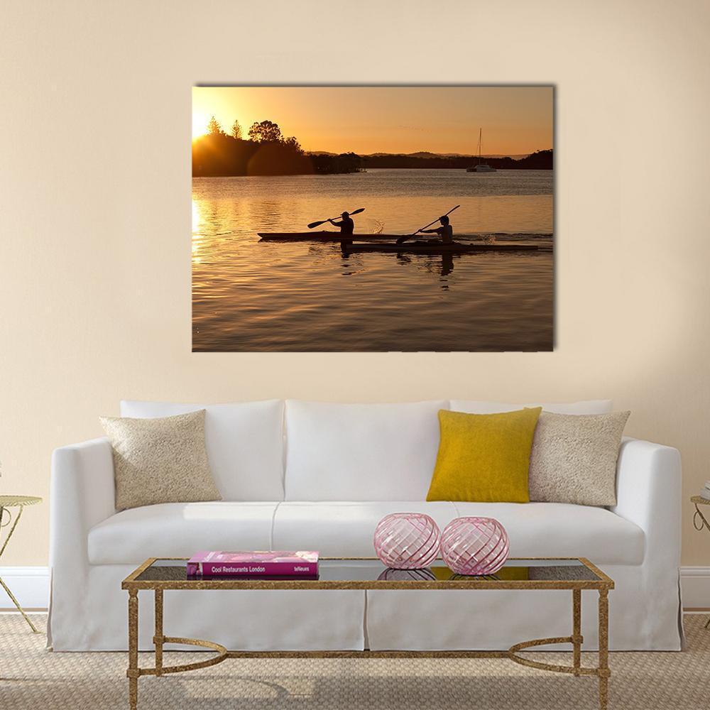 Sunset Kayaking on Calm Waters Canvas Wall Art in brown, orange and yellow, single panel hung on a wall