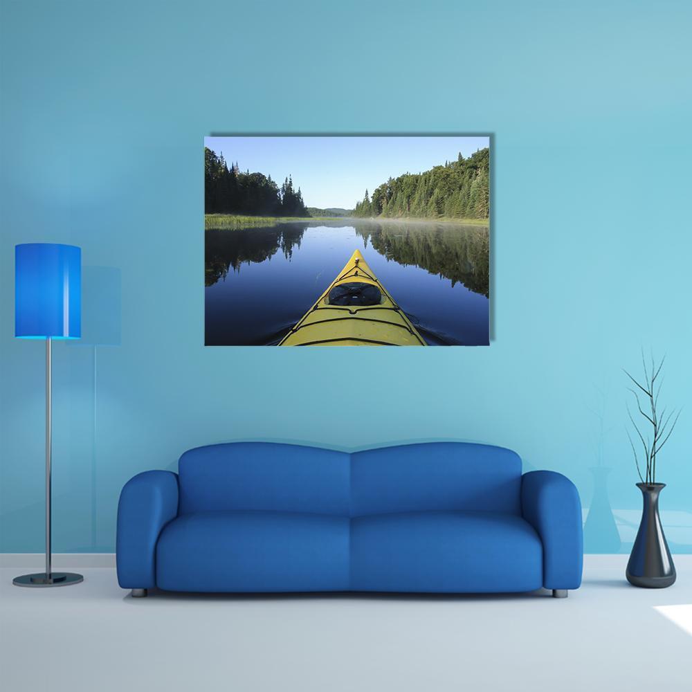 Kayak on a Quebec Lake Canvas Wall Art in yellow, green and blue, single panel hung on a wall