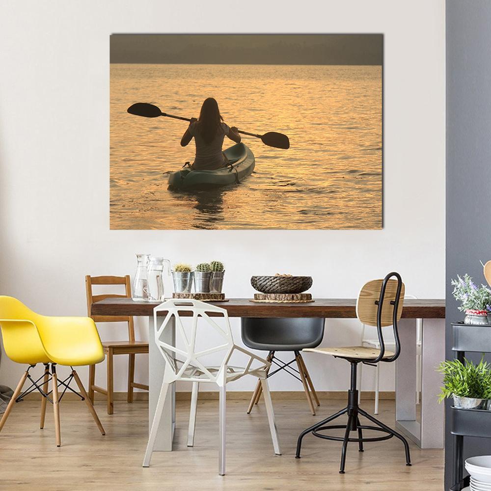Woman Kayaking at Sunrise Canvas Wall Art in brown, orange and yellow, single panel hung on a wall