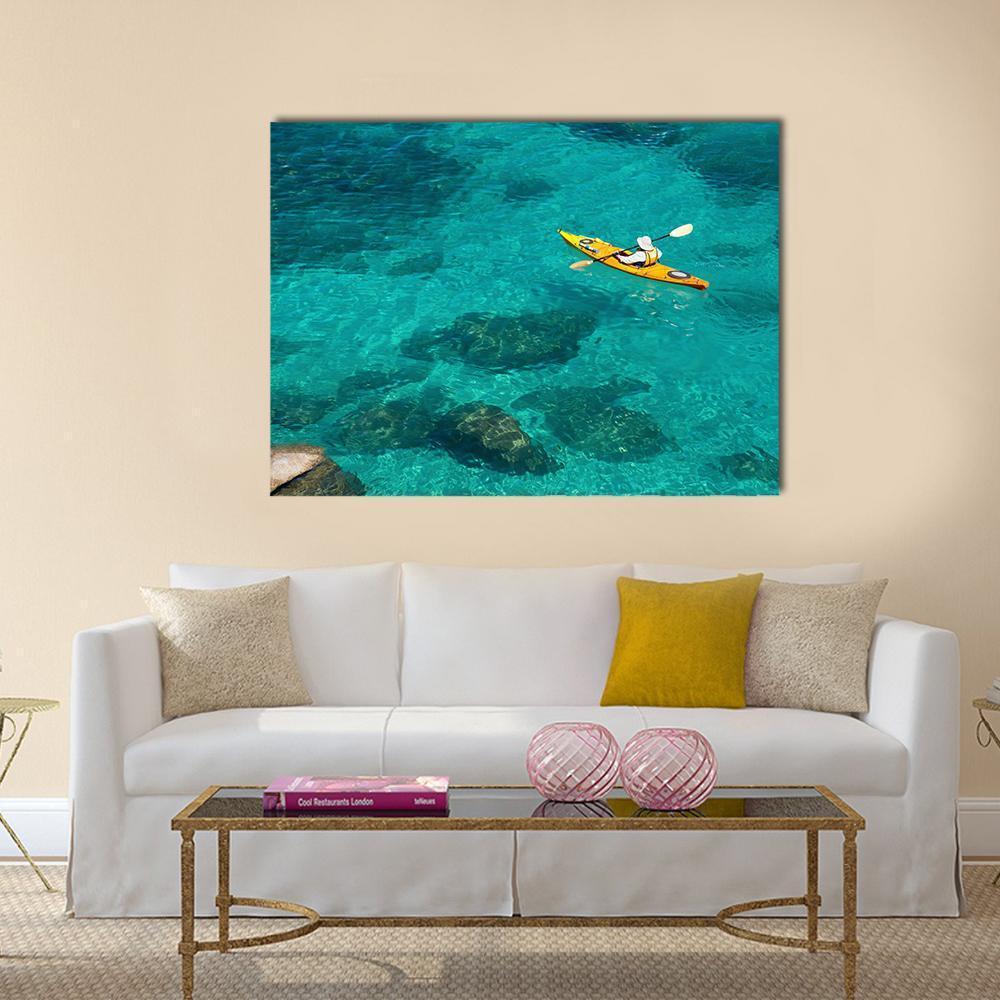 Yellow Kayak in Turquoise Water Canvas Wall Art in yellow, green and blue, single panel hung on a wall