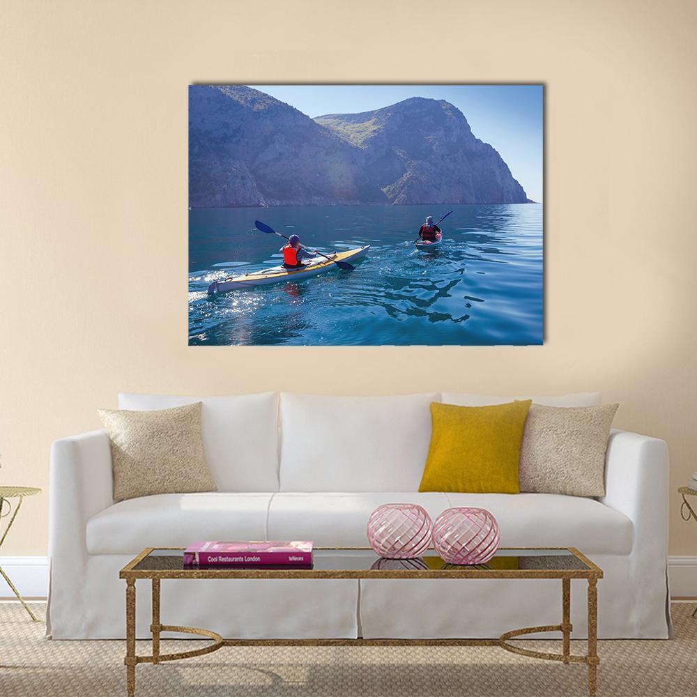 Kayakers in Serene Ocean Scene Canvas Wall Art in gray and blue, single panel hung on a wall
