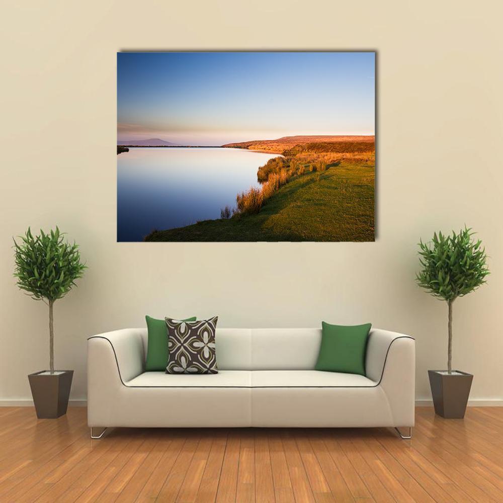 Keepers Pond at Sunset Canvas Wall Art in orange, yellow and blue, single panel hung on a wall