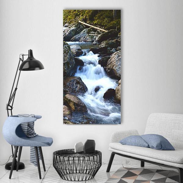 Kelchsau Waterfall in Lush Forest Vertical Canvas Wall Art in white, gray and green, single vertical panel hung on a wall