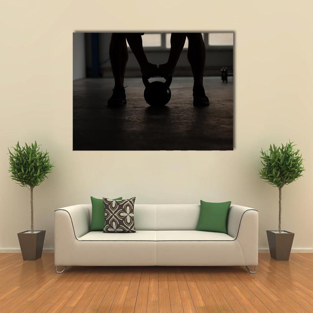 Kettlebell Workout Silhouette Canvas Wall Art in black and gray, single panel hung on a wall