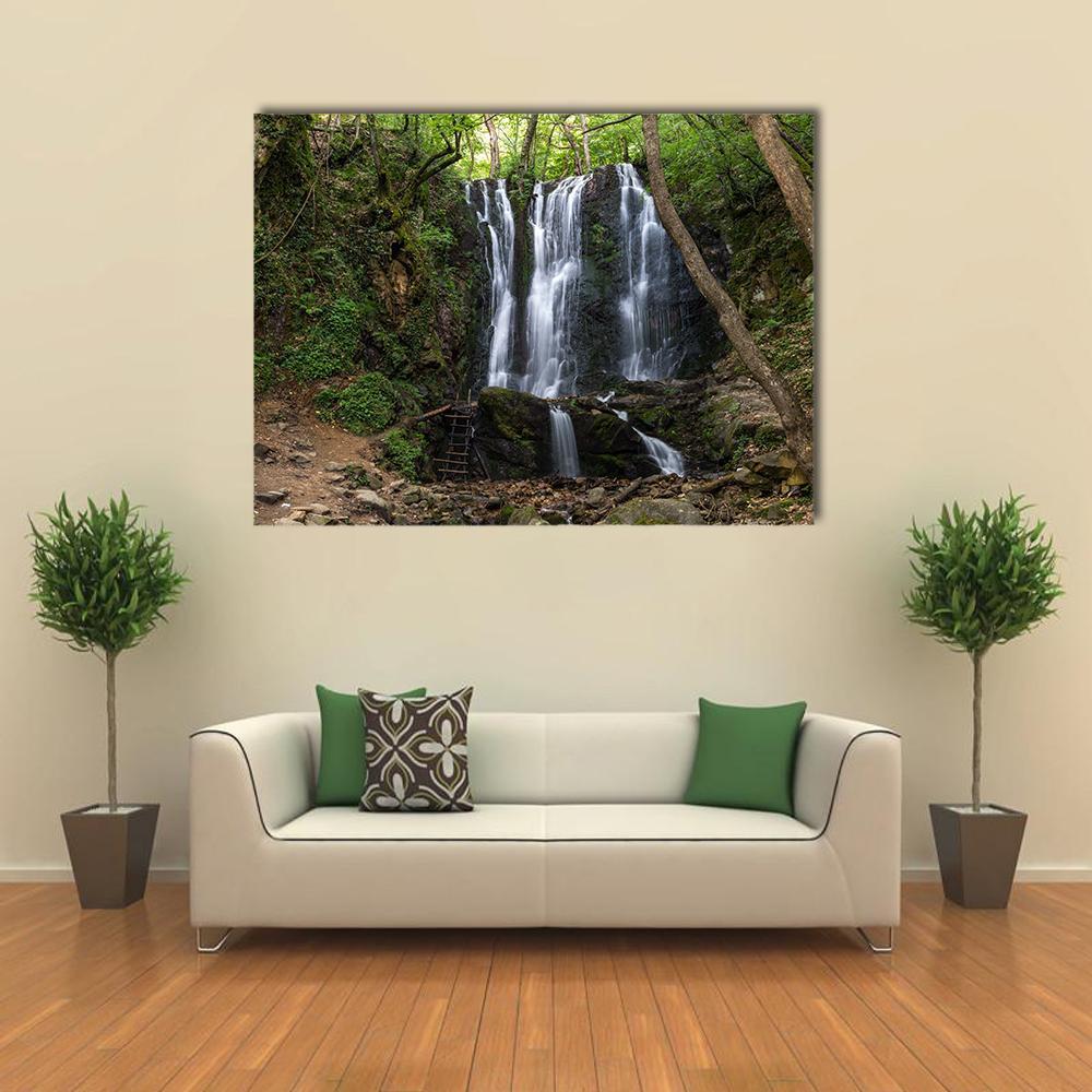 Koleshino Waterfalls Canvas Wall Art in white, brown and green, single panel hung on a wall