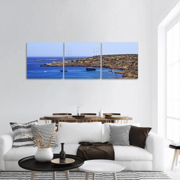 Coastal Bay with Sailboats Panoramic Canvas Wall Art in white, brown and blue, hung on a wall