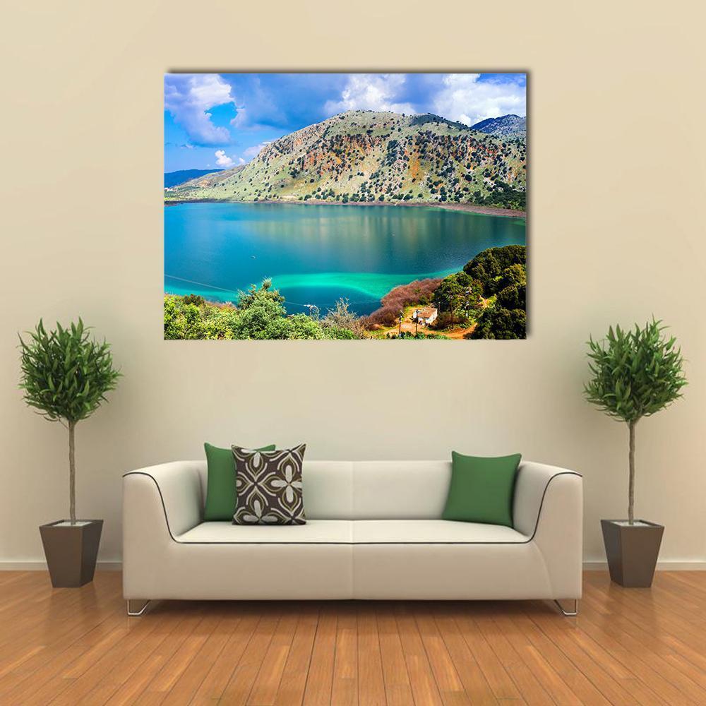 Kournas Lake Turquoise Shoreline Canvas Wall Art in green and blue, single panel hung on a wall