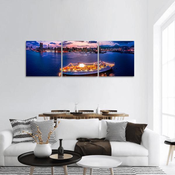 Hong Kong Harbor Twilight Cityscape Panoramic Canvas Wall Art in orange, blue and purple, hung on a wall