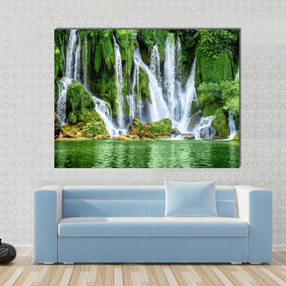 Kravica Waterfall Canvas Wall Art in white and green, single panel hung on a wall