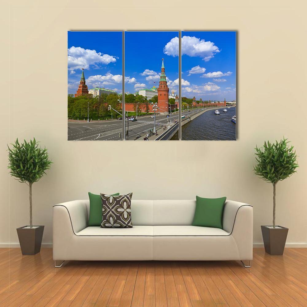 Kremlin Towers Over the Moscow River Canvas Wall Art in gray, red and blue, 3 panel horizontal set hung on a wall