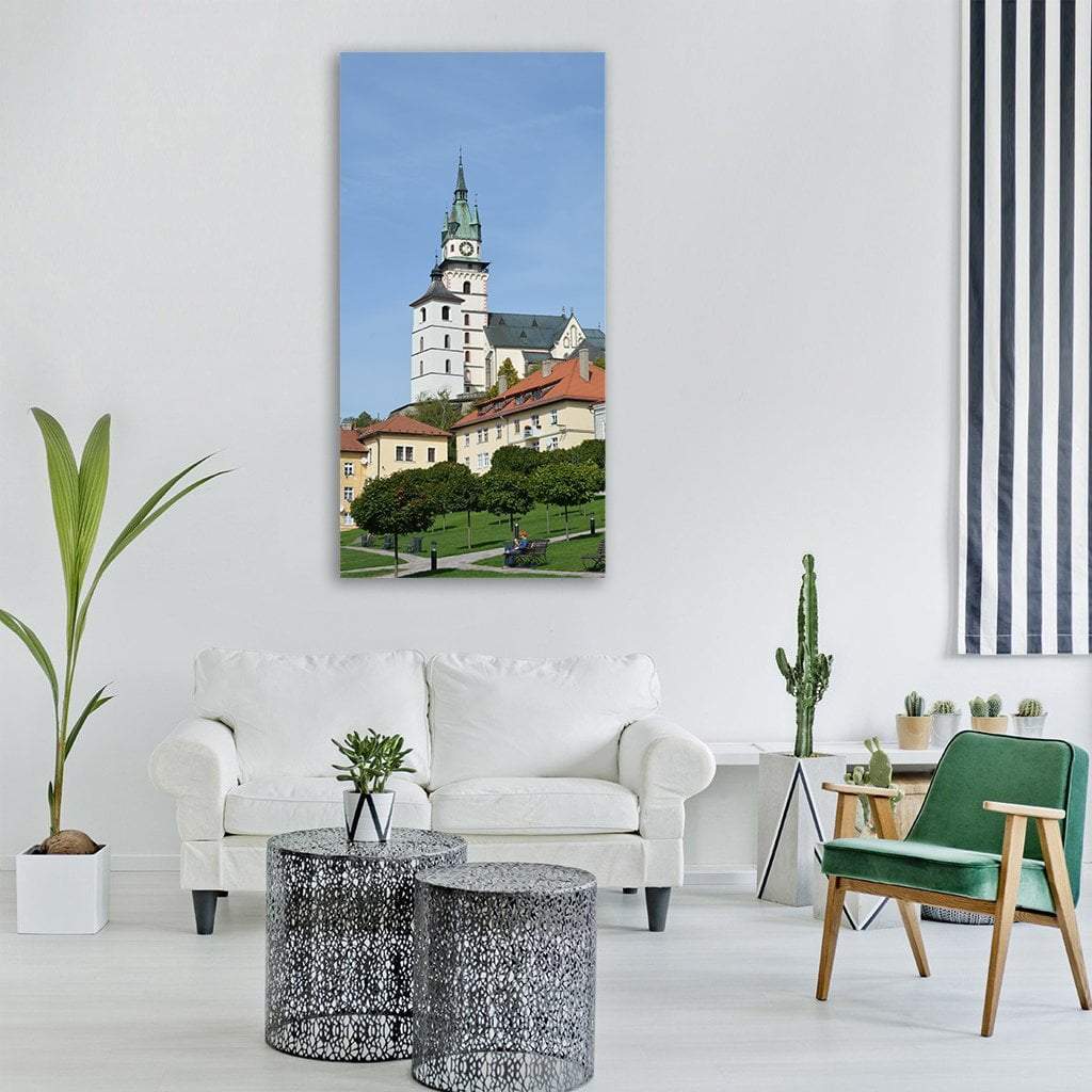 Kremnica Castle, Slovakia Vertical Canvas Wall Art in white, green and blue, single vertical panel hung on a wall