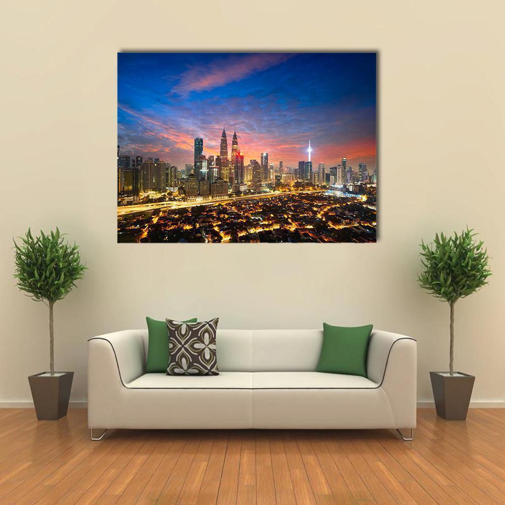 Kuala Lumpur Dusk Skyline with Petronas Twin Towers Canvas Wall Art in orange, yellow and blue, single panel hung on a wall