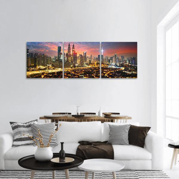 Kuala Lumpur Skyline at Dusk Panoramic Canvas Wall Art in orange, yellow and blue, hung on a wall