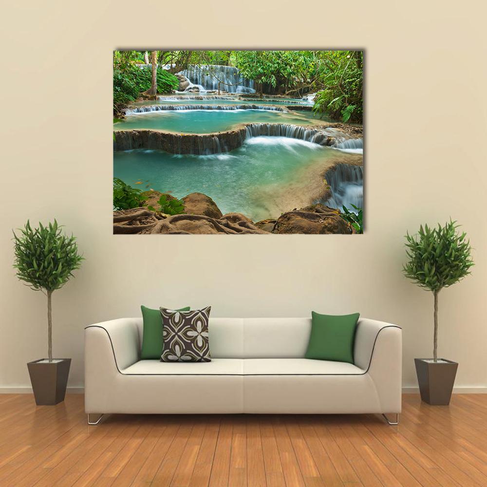 Kuang Si Waterfall Canvas Wall Art in brown, green and blue, single panel hung on a wall