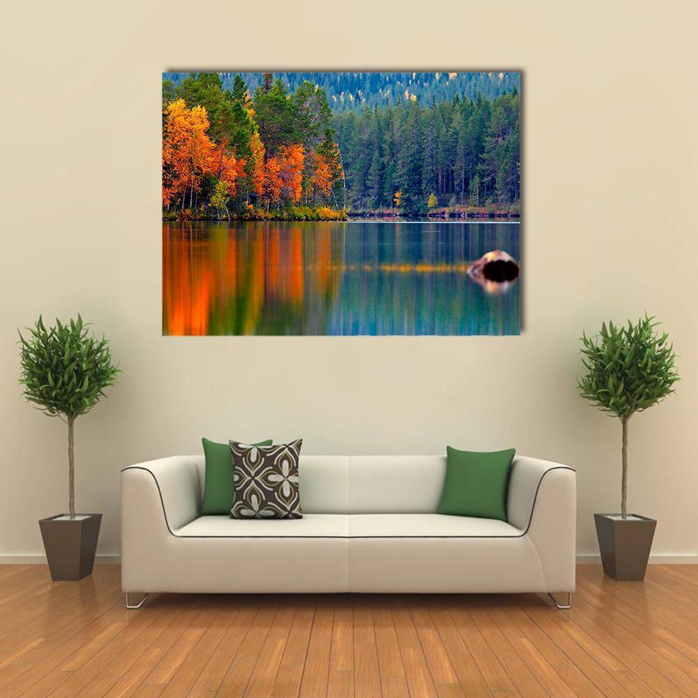 Autumn Lake with Forest Reflection Canvas Wall Art in orange, green and blue, single panel hung on a wall