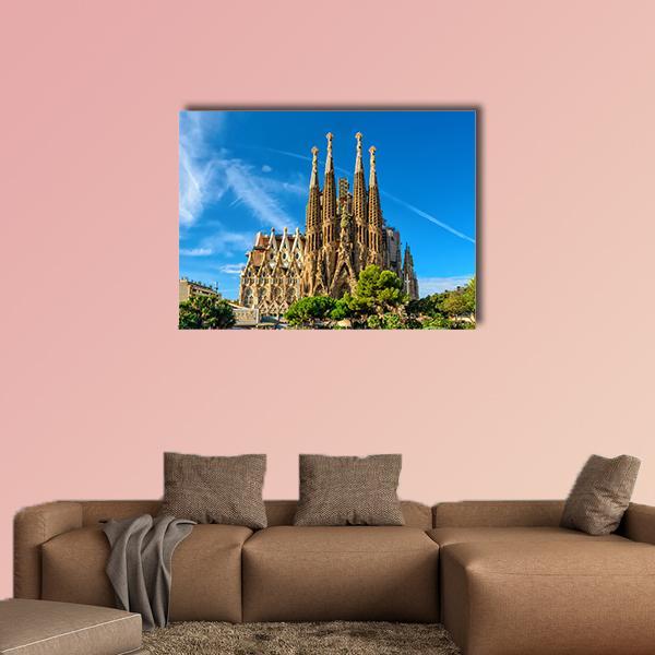 La Sagrada Familia Cathedral Spires Canvas Wall Art in beige, brown and blue, single panel hung on a wall