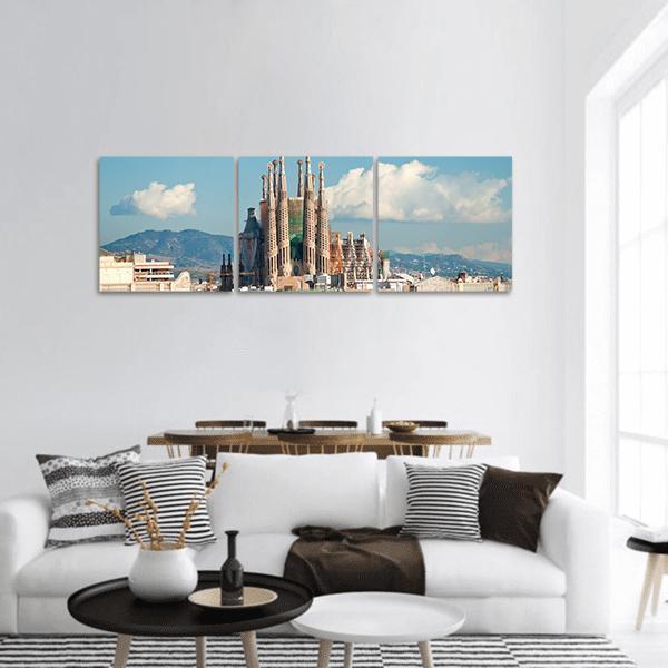 La Sagrada Família Basilica, Barcelona Panoramic Canvas Wall Art in beige, brown and blue, hung on a wall
