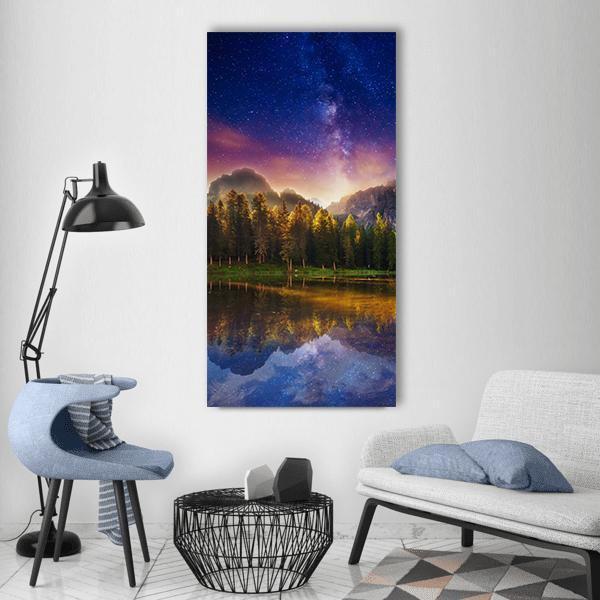 Milky Way Over Alpine Lake Reflection Vertical Canvas Wall Art in yellow, blue and purple, single vertical panel hung on a wall