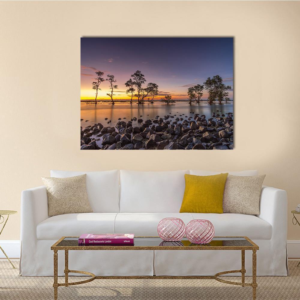 Laguna Beach Sunset with Mangrove Silhouettes Canvas Wall Art in orange, blue and purple, single panel hung on a wall