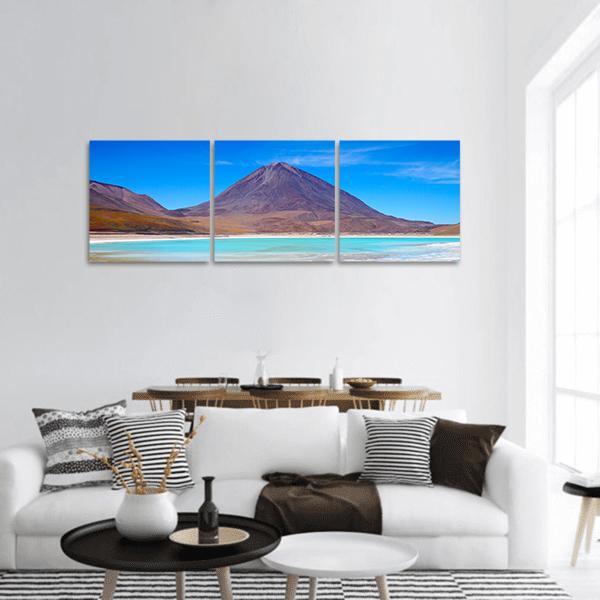 Laguna Verde Turquoise Lake and Volcano Panoramic Canvas Wall Art in brown and blue, hung on a wall