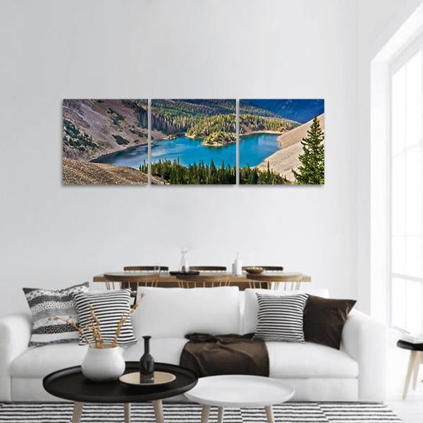 Lake Agnes Alpine Lake View Panoramic Canvas Wall Art in brown, green and blue, hung on a wall