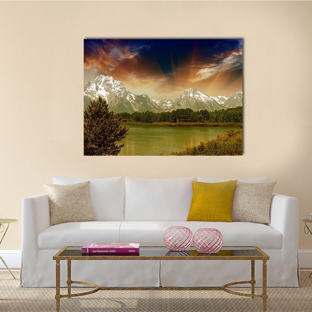 Grand Teton Sunset Over Mountains Canvas Wall Art in orange, yellow and blue, single panel hung on a wall