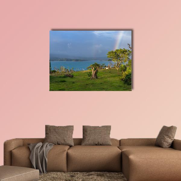 Lake Arenal with Rainbow and Lone Tree Canvas Wall Art in green and blue, single panel hung on a wall