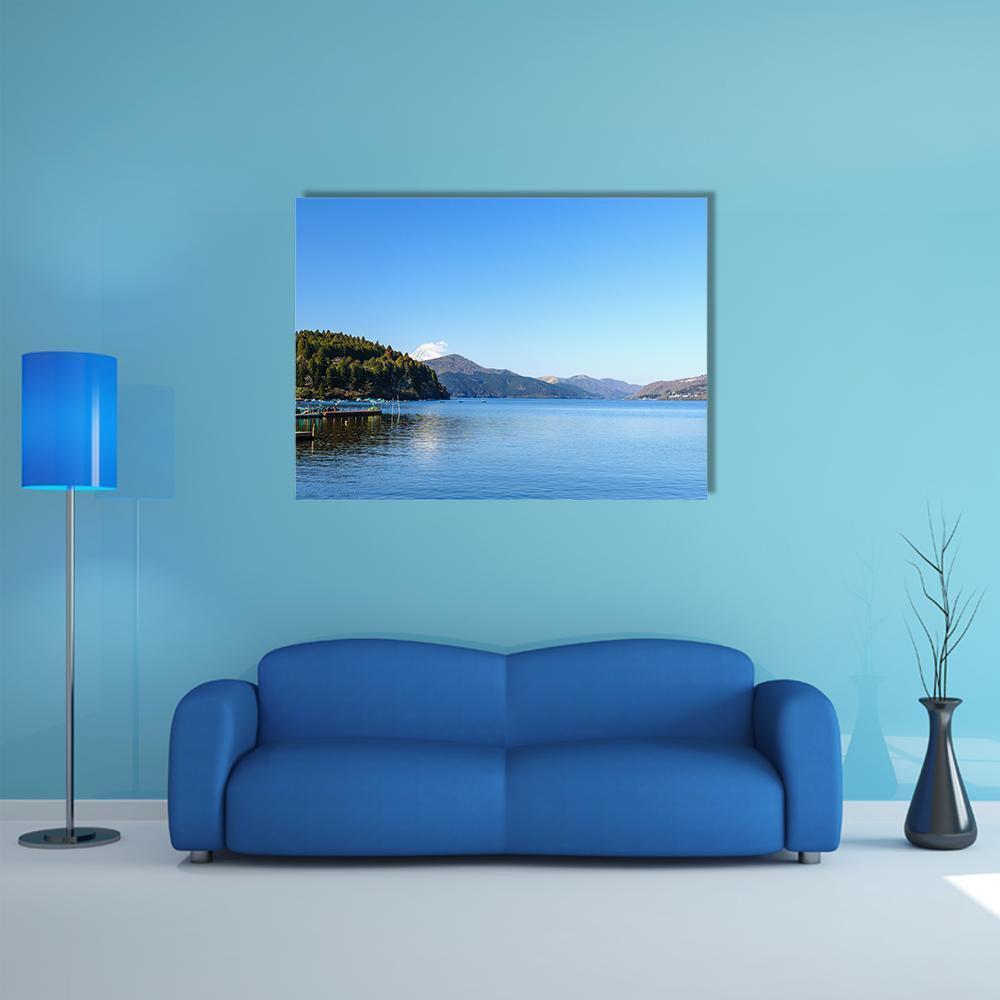 Lake Ashi Boats and Snow-capped Mountains Canvas Wall Art in blue, single panel hung on a wall