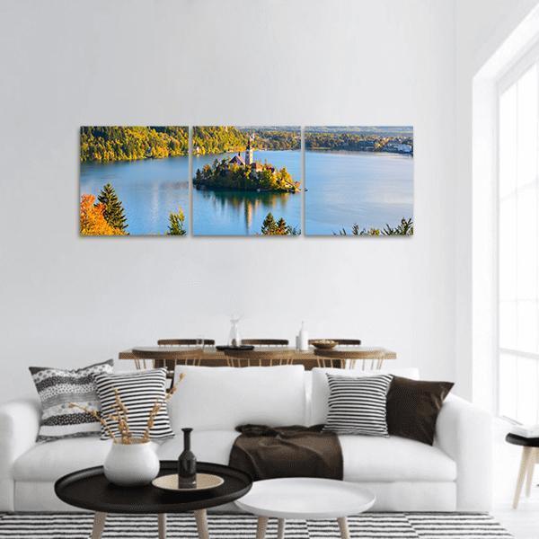 Lake Bled Island Church at Golden Hour Panoramic Canvas Wall Art in gold, green and blue, hung on a wall